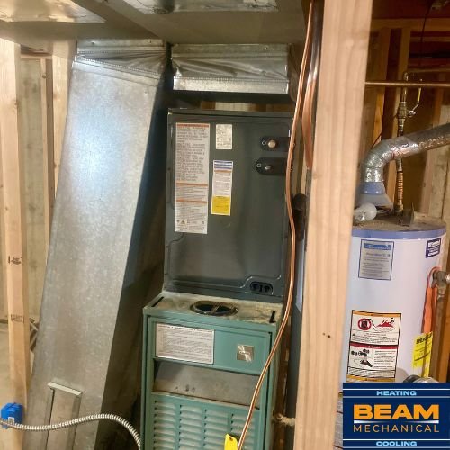 New central AC evaporator coil installed above a furnace in a Denver-area home